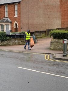 Walking with a full bag of litter