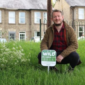local resident Dan at the Recreation Ground next to a Wild Area sign